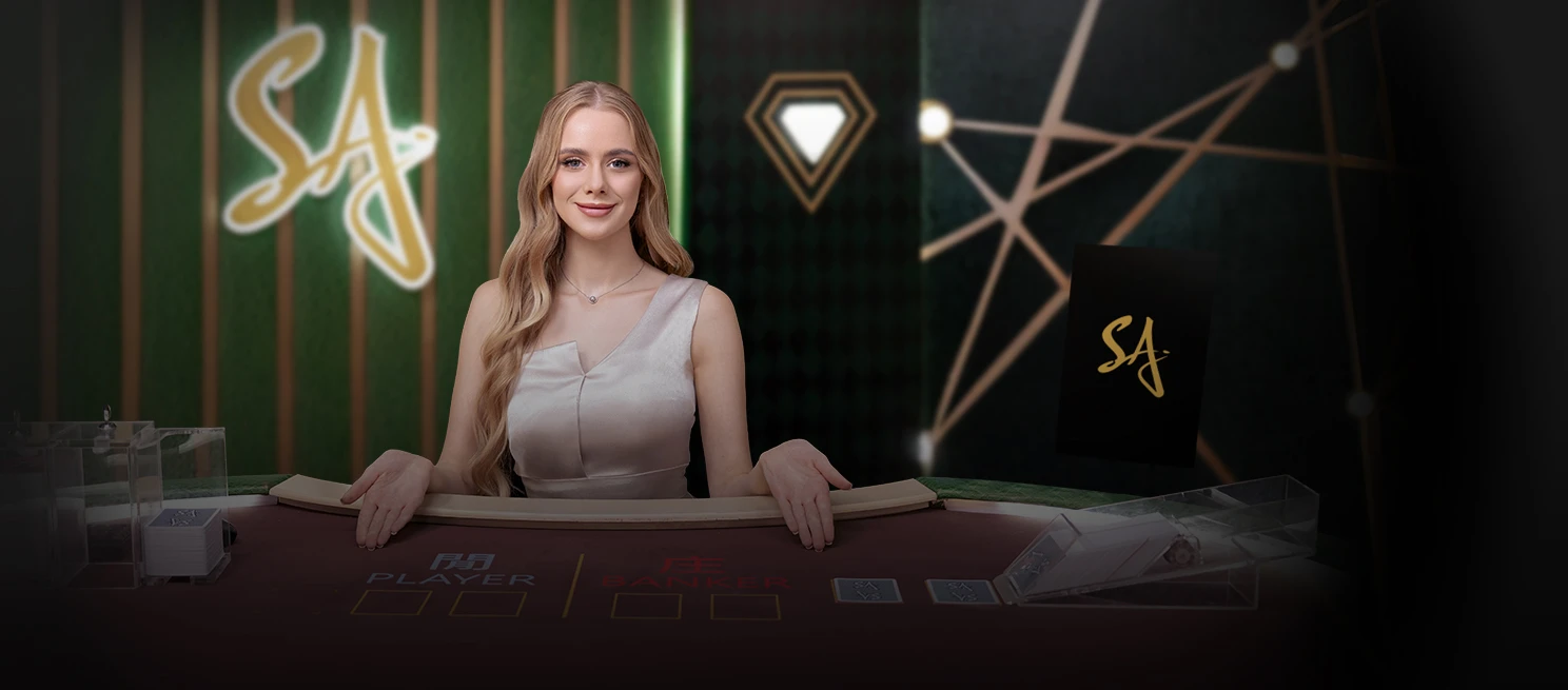 Smiling woman in a red dress seated at a casino table, elegantly presenting playing cards, with gaming tables in the background.
